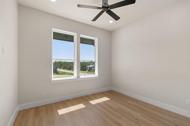 spare room featuring baseboards, ceiling fan, light wood finished floors, and recessed lighting