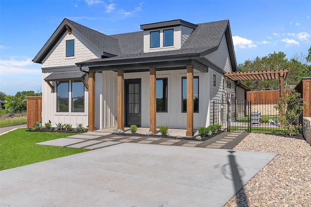 view of front facade featuring board and batten siding, fence, covered porch, a pergola, and roof with shingles