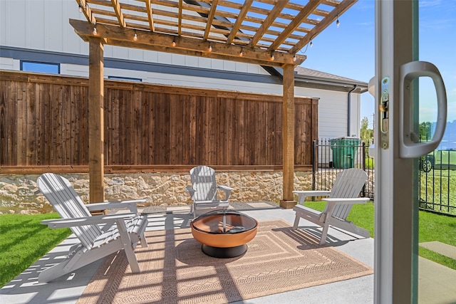 view of patio / terrace with an outdoor fire pit, a pergola, and fence
