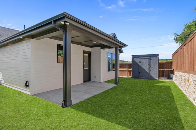 back of property with a yard, a patio, a shed, an outbuilding, and a fenced backyard