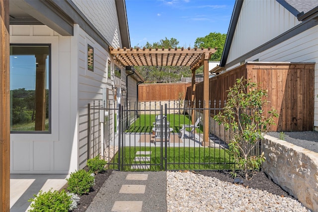 view of gate with a yard, a pergola, and fence private yard