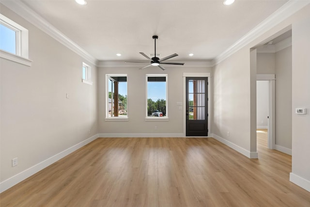 empty room featuring a ceiling fan, ornamental molding, light wood finished floors, and recessed lighting