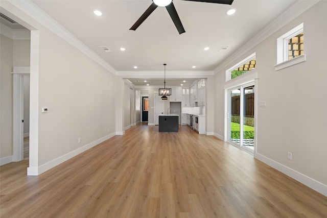 unfurnished living room with ornamental molding, visible vents, recessed lighting, a ceiling fan, and light wood-style floors