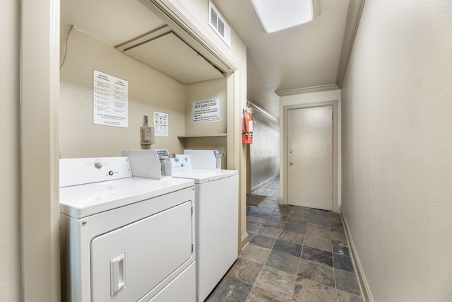 7908 Royal Ln Unit 122B, Dallas, TX 75230 - community laundry room featuring baseboards, stone finish flooring, visible vents, and washer and clothes dryer