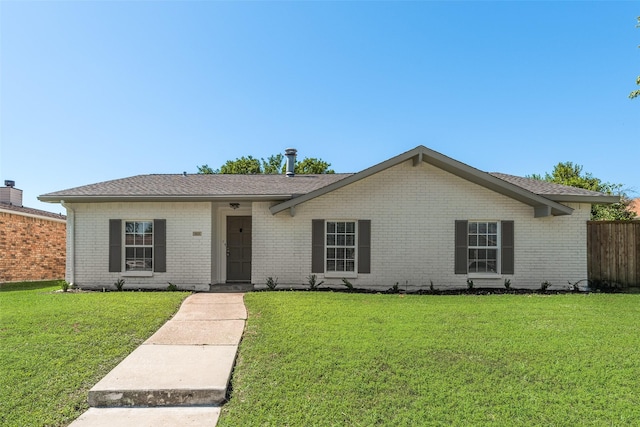 ranch-style home featuring brick siding and a front yard
