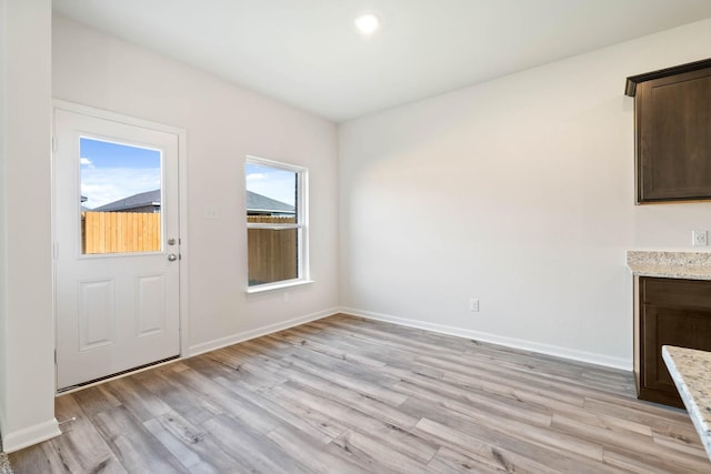 423 Condie Russell Ave, Venus, TX 76084 - unfurnished living room with light wood-style flooring and baseboards