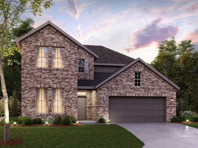 traditional home featuring brick siding, an attached garage, concrete driveway, a front yard, and roof with shingles
