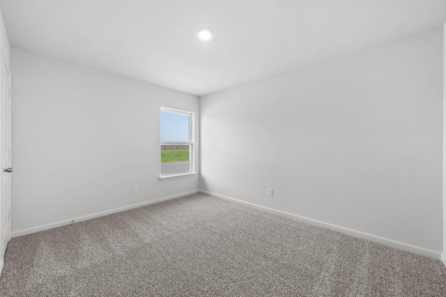 empty room with carpet and baseboards