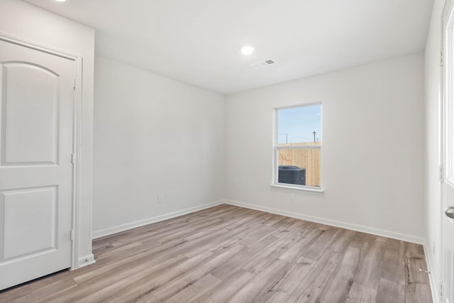 unfurnished room with light wood finished floors, baseboards, and recessed lighting