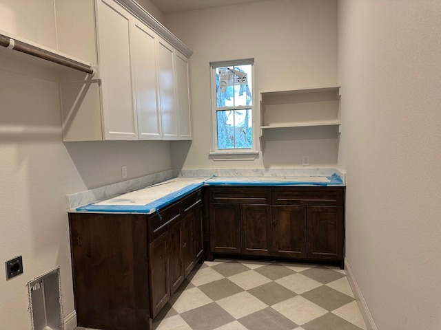 1099 Silver Sage Trl, Weatherford, TX 76085 - laundry room with light flooring, electric dryer hookup, cabinet space, and a desk