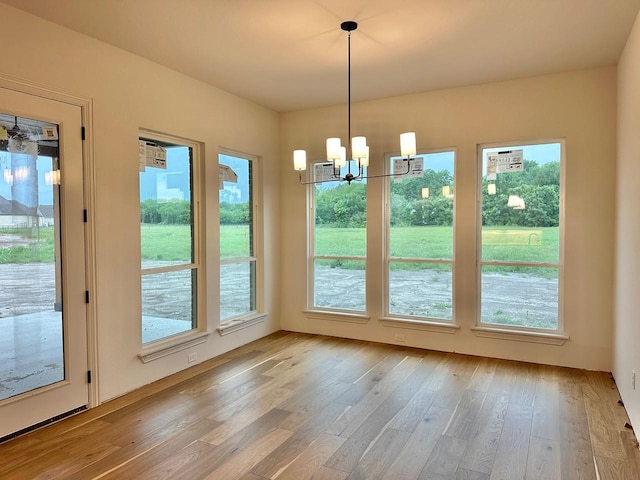 1099 Silver Sage Trl, Weatherford, TX 76085 - unfurnished dining area featuring a chandelier and light wood-style flooring