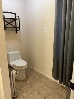 1804 Chicory Ln, Arlington, TX 76010 - bathroom with tile patterned flooring, toilet, and baseboards