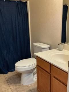 1804 Chicory Ln, Arlington, TX 76010 - full bathroom with toilet, vanity, tile patterned floors, and a shower with curtain
