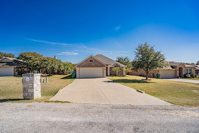 ranch-style home featuring a front lawn, concrete driveway, brick siding, and an attached garage