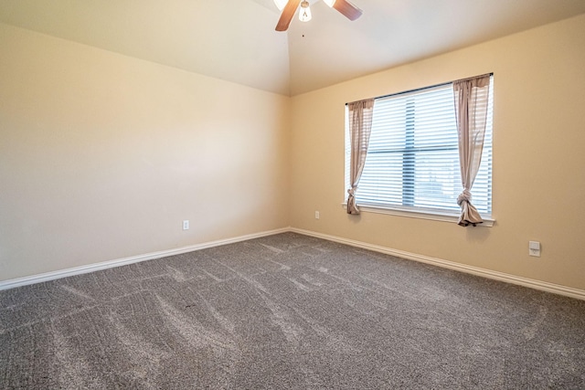 unfurnished room with dark carpet, vaulted ceiling, baseboards, and ceiling fan
