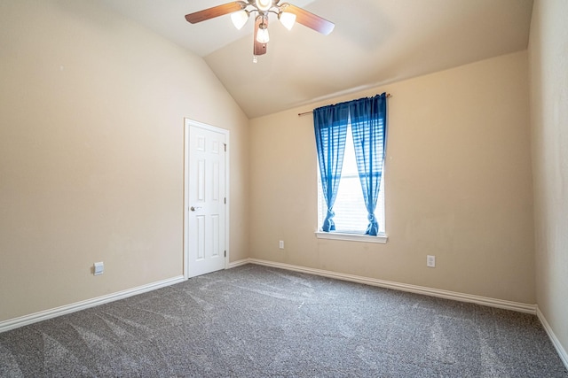 unfurnished room featuring baseboards, ceiling fan, carpet floors, and vaulted ceiling