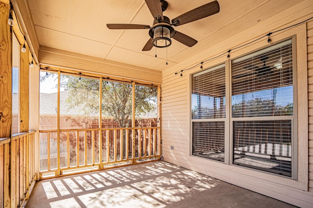 unfurnished sunroom featuring a ceiling fan