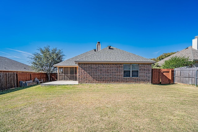 rear view of property featuring a fenced backyard, a patio area, a shingled roof, and a lawn