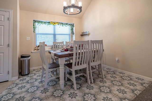 tiled dining room with high vaulted ceiling, a notable chandelier, and baseboards