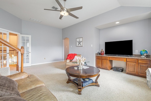 1804 Goodnight Ln, Allen, TX 75002 - living room with lofted ceiling, light colored carpet, arched walkways, a ceiling fan, and stairs