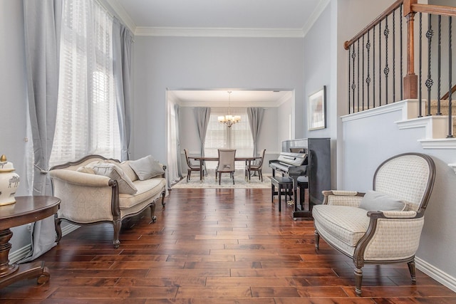 1804 Goodnight Ln, Allen, TX 75002 - living area with ornamental molding, a chandelier, stairway, dark wood-style floors, and baseboards