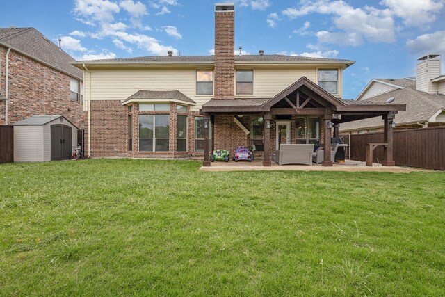 1804 Goodnight Ln, Allen, TX 75002 - rear view of house with a patio area, a storage unit, an outbuilding, brick siding, and a chimney