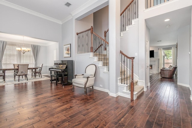 1804 Goodnight Ln, Allen, TX 75002 - stairs with wood finished floors, a chandelier, a high ceiling, crown molding, and baseboards