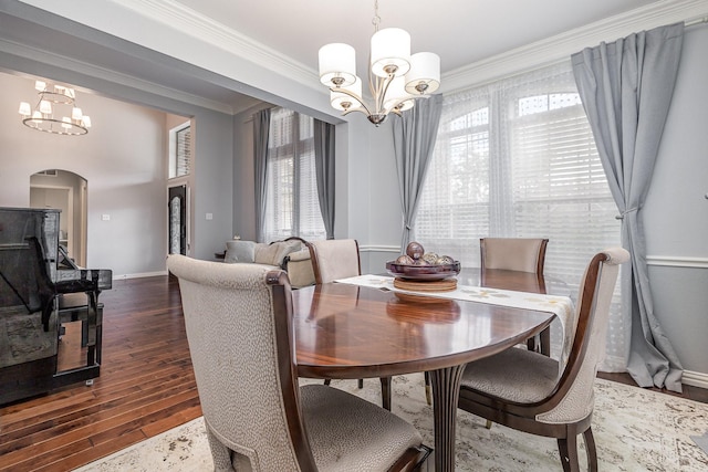 1804 Goodnight Ln, Allen, TX 75002 - dining space featuring a chandelier, arched walkways, crown molding, dark wood-style floors, and baseboards
