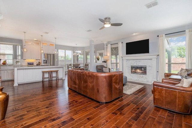1804 Goodnight Ln, Allen, TX 75002 - living room featuring dark wood finished floors, ceiling fan, a premium fireplace, and a chandelier
