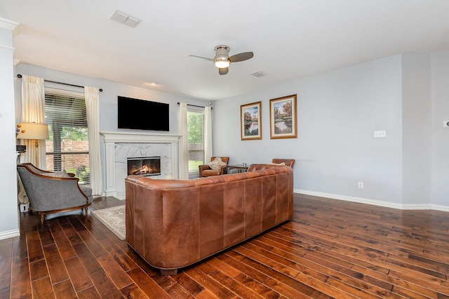 1804 Goodnight Ln, Allen, TX 75002 - living area with a high end fireplace, dark wood finished floors, a ceiling fan, and baseboards