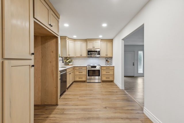 6200 Ravenswood Dr, Fort Worth, TX 76112 - kitchen with appliances with stainless steel finishes, light wood-style flooring, light countertops, backsplash, and light brown cabinets