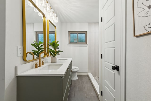 6200 Ravenswood Dr, Fort Worth, TX 76112 - full bath with toilet, double vanity, tiled shower, baseboards, and tile patterned floors