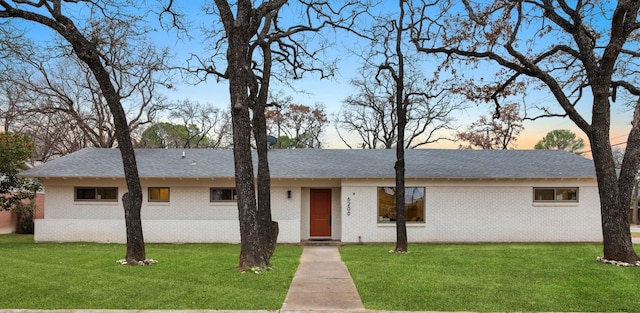 6200 Ravenswood Dr, Fort Worth, TX 76112 - ranch-style house with brick siding, a front yard, and a shingled roof