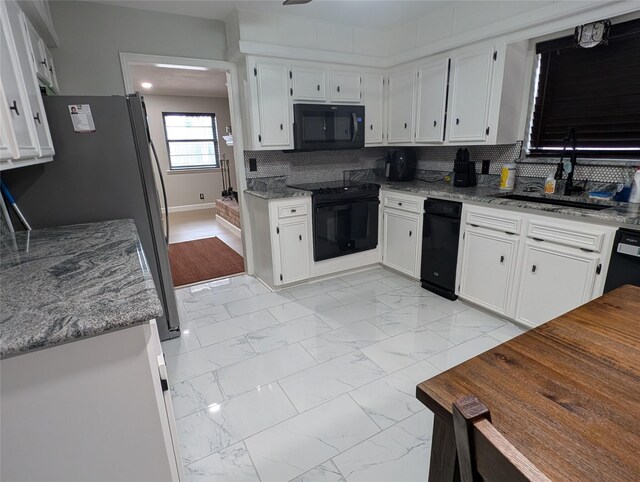 3209 Mimosa Dr, Sherman, TX 75092 - kitchen featuring a sink, light marble finish floors, black appliances, backsplash, and white cabinetry