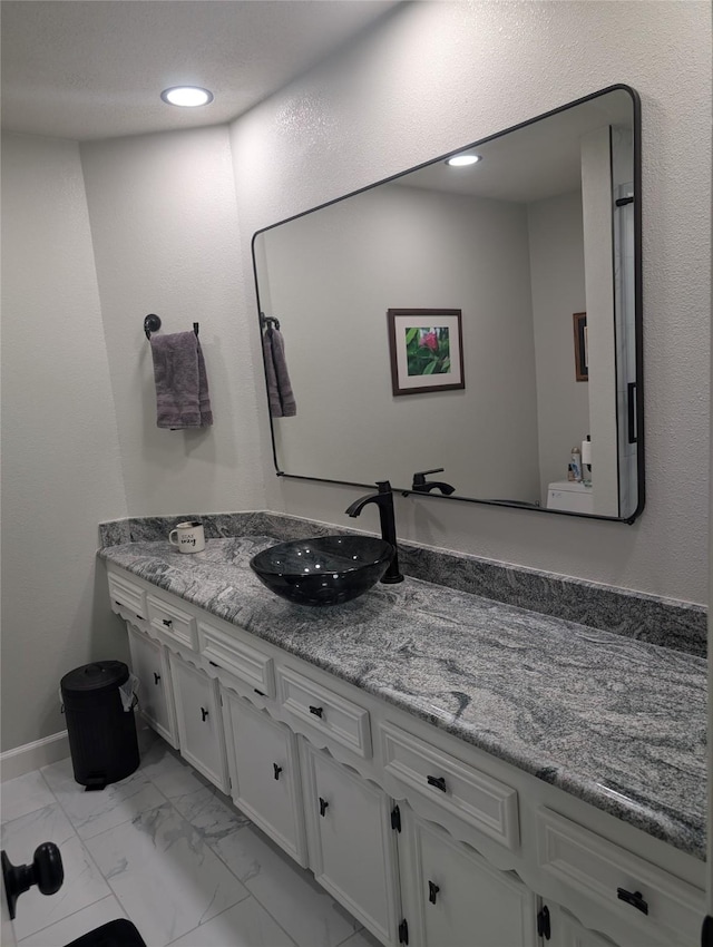 3209 Mimosa Dr, Sherman, TX 75092 - bathroom featuring marble look tile flooring, vanity, and recessed lighting