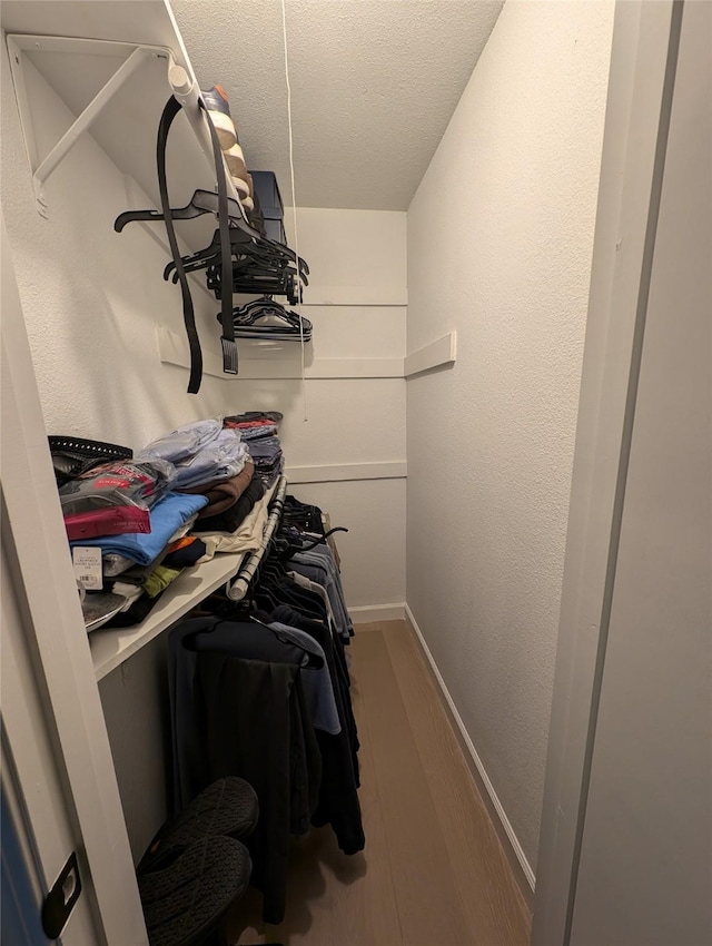 3209 Mimosa Dr, Sherman, TX 75092 - walk in closet with wood finished floors