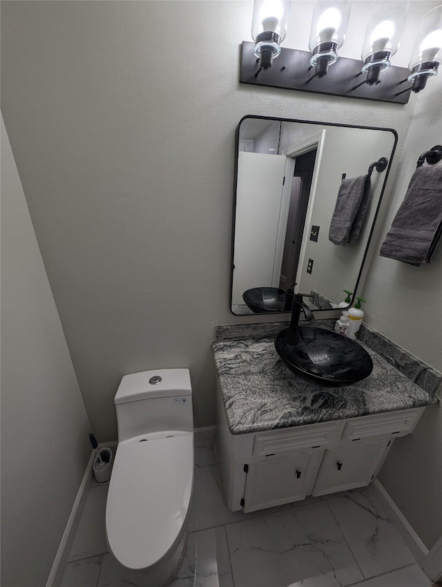 3209 Mimosa Dr, Sherman, TX 75092 - half bathroom featuring marble look tiles, toilet, vanity, and baseboards