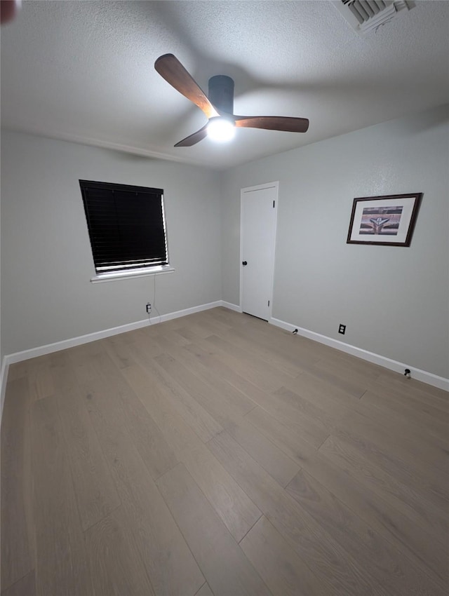 3209 Mimosa Dr, Sherman, TX 75092 - empty room featuring a ceiling fan, wood finished floors, a textured ceiling, and baseboards