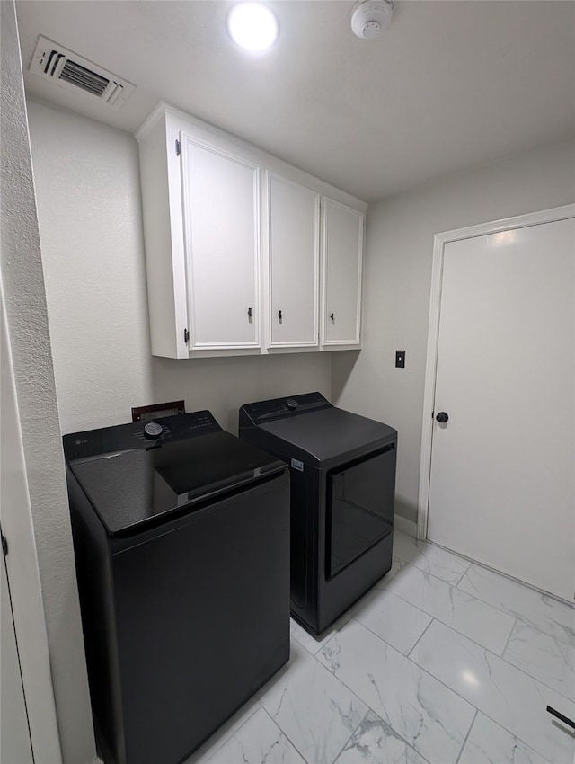 3209 Mimosa Dr, Sherman, TX 75092 - laundry area with washing machine and dryer, cabinet space, and light marble finish flooring