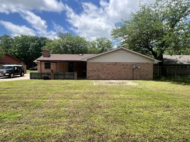 3209 Mimosa Dr, Sherman, TX 75092 - ranch-style home with brick siding, a front lawn, and a chimney