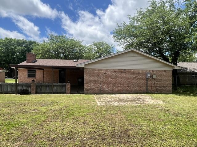 3209 Mimosa Dr, Sherman, TX 75092 - rear view of property featuring brick siding, a patio, and a chimney