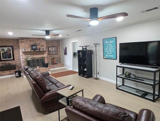 3209 Mimosa Dr, Sherman, TX 75092 - living area with a ceiling fan, a brick fireplace, light wood-type flooring, and visible vents