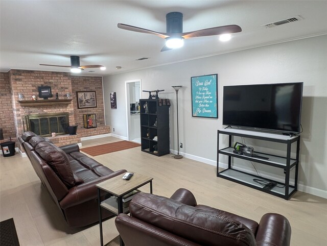 3209 Mimosa Dr, Sherman, TX 75092 - living room with wood finished floors, a brick fireplace, visible vents, baseboards, and ceiling fan