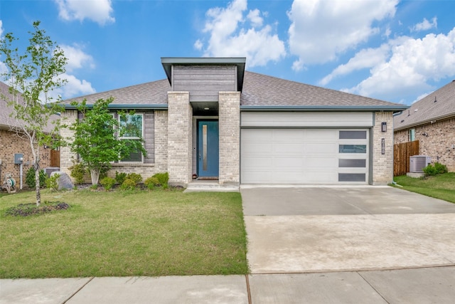 2100 Blackcap St, Denton, TX 76205 - view of front facade with brick siding, an attached garage, central AC, concrete driveway, and a front lawn
