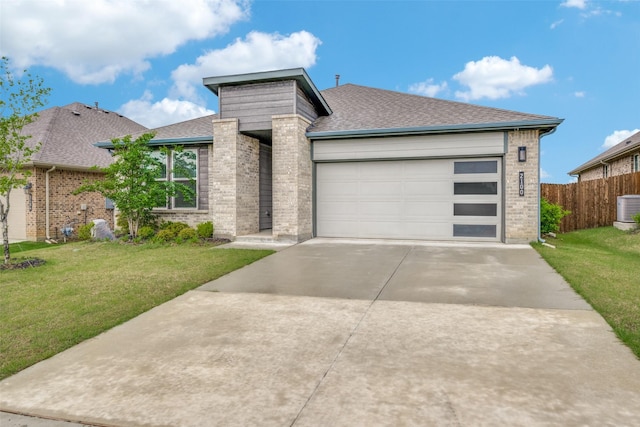 2100 Blackcap St, Denton, TX 76205 - prairie-style home with an attached garage, brick siding, roof with shingles, and a front yard