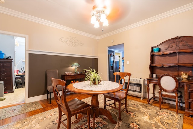 1501 W Crawford St W, Denison, TX 75020 - dining space with crown molding, a baseboard radiator, heating unit, and wood finished floors