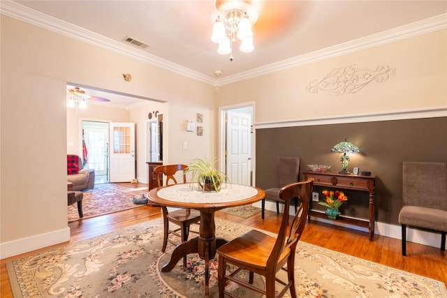1501 W Crawford St W, Denison, TX 75020 - dining room with wood finished floors, a ceiling fan, crown molding, visible vents, and baseboards