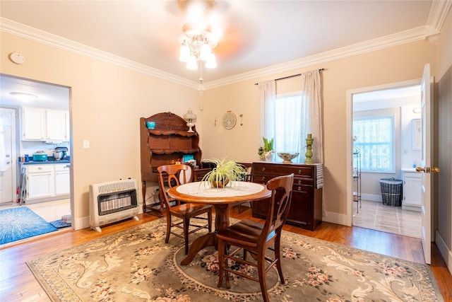 1501 W Crawford St W, Denison, TX 75020 - dining space featuring heating unit, plenty of natural light, ornamental molding, and light wood-style floors