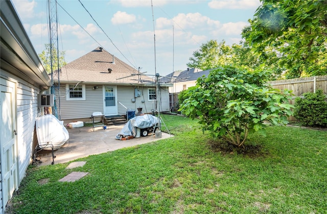 1501 W Crawford St W, Denison, TX 75020 - rear view of property featuring roof with shingles, a patio area, a yard, a fenced backyard, and entry steps