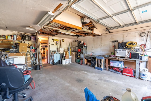 1501 W Crawford St W, Denison, TX 75020 - garage featuring a workshop area and a garage door opener
